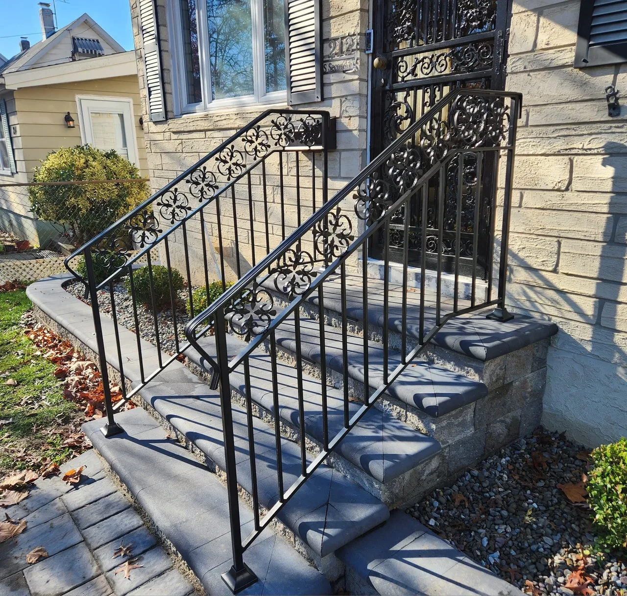 Ornate metal railing on stone steps